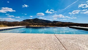 A swimming pool with a mountain backdrop.