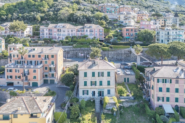Stunning hillside neighborhood with a mix of pastel-colored buildings and lush greenery.