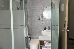 A modern bathroom with a glass shower enclosure, a toilet, a sink with a mirror, and a towel rack. - Waiting Qingju Hotel (9th People's Hospital Lujiabang Road Subway Station Branch) (Shanghai)