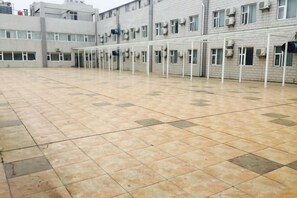A spacious indoor area with a tiled floor and multiple doorways leading to rooms. - Yongle Star Hotel (Shiyan Fang County) (Fang County)