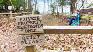 A wooden sign with "PRIVATE PROPERTY RESIDENTS ONLY" and "QUIET PLEASE" written on it. - Lakefront Cottage with Hot Tub & Beach Access (Fennville)