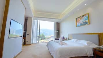 A hotel room with a large bed, a television, a painting, and a view of the outdoors.