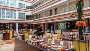 A multi-level hotel lobby with a grand piano, seating areas, and decorative vases. - Chaozhou Taian Tang Ruiting Western Suburb Hot Spring Hotel (Chaozhou)
