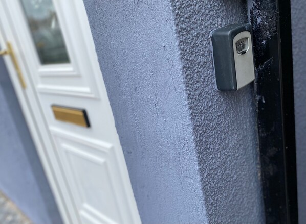 A door with a keypad lock and a keyhole.