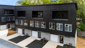A modern two-story building with a black exterior and multiple windows.