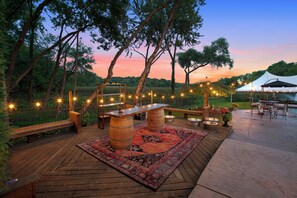 Relax on the patio surrounded by lush trees and enjoy the serene atmosphere.