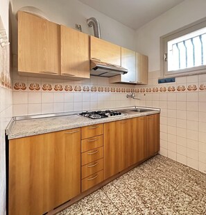 Fridge, high chair, cookware/dishes/utensils