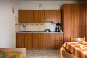 Fridge, coffee/tea maker, high chair, cookware/dishes/utensils