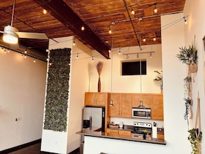 A modern kitchen with wooden cabinets, a built-in oven, and a refrigerator.