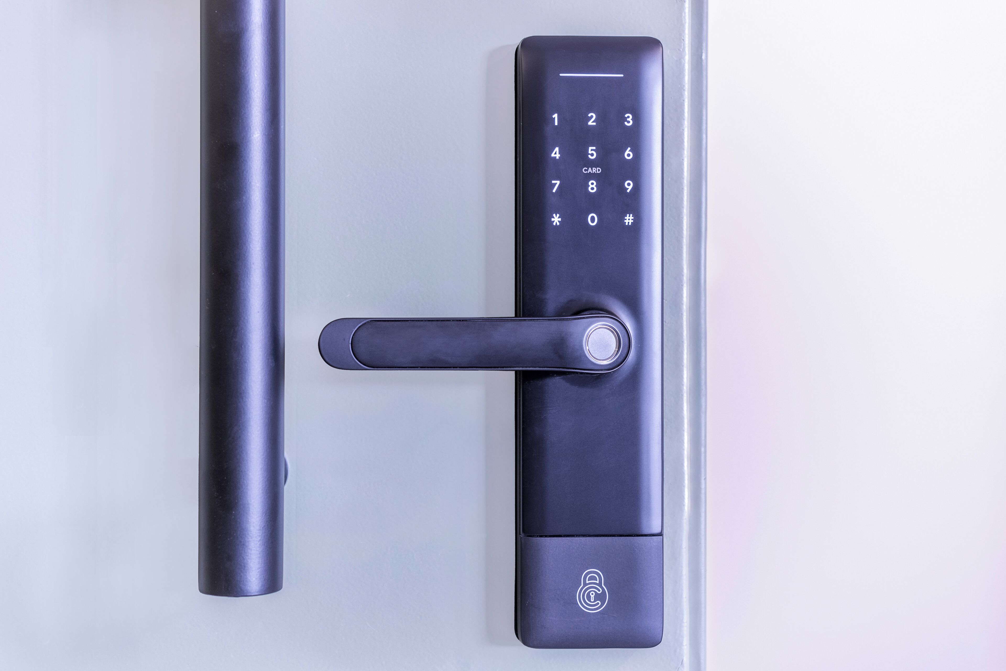 A modern door lock with a numeric keypad and a keyhole.