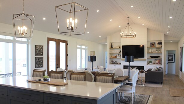 A spacious kitchen with a large island, modern pendant lights, and a dining area with chairs and a table. - Water View Vacation Home Located in Rustico- Subdivision Access To Beach. (Rustico)