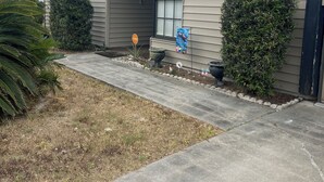 A residential house with a number 2447, a front porch, and a small garden area. - Charming 2-bedroom house with WiFi, AC in fabulous Deltona , Florida (Deltona)