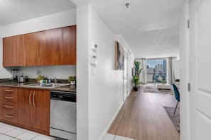 A modern kitchen with wooden cabinets, a dishwasher, and a countertop with appliances.