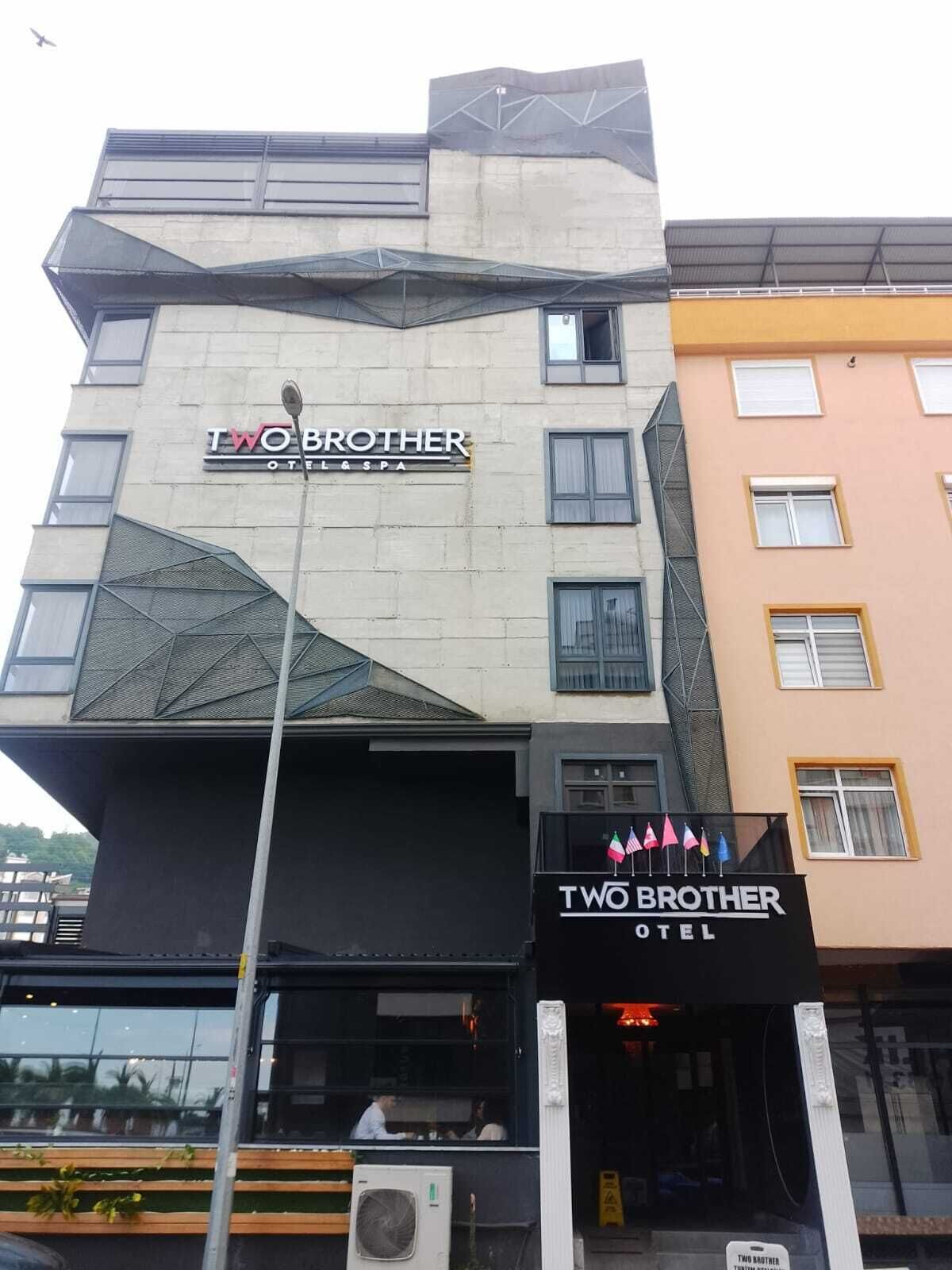 A building with a sign for 'Two Brother Hotel & Spa'.