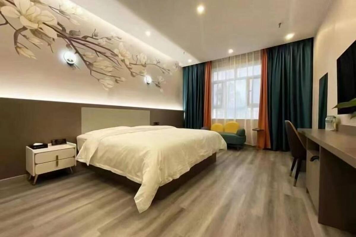 Une chambre moderne avec un grand lit, un bureau et une chaise.