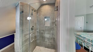 A glass-enclosed shower with a tiled floor and a small window. - Sunday Villas Sunday Funday by Silver Sands Vacation Rentals (Port Aransas)