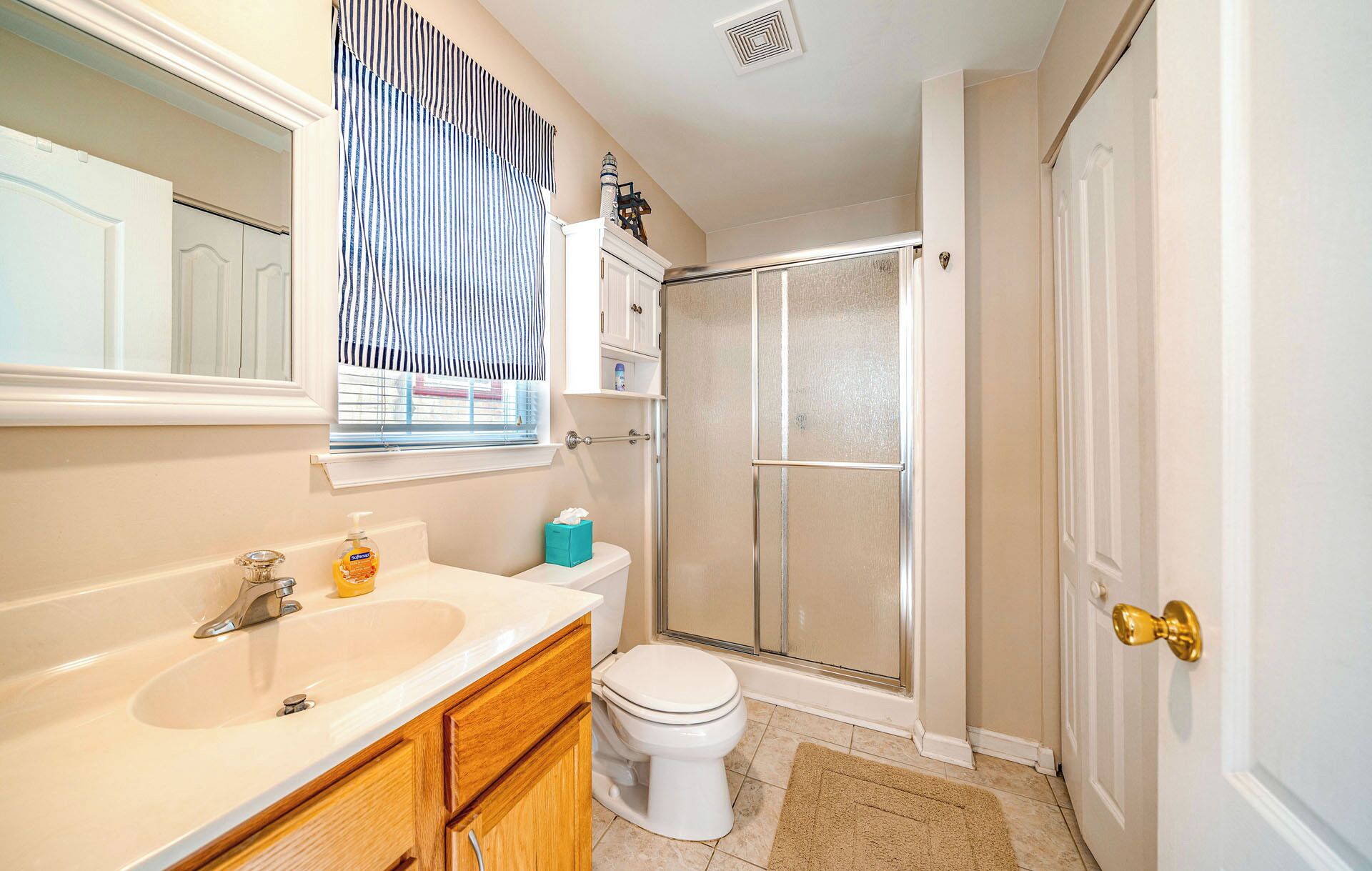 A bathroom with a sink, toilet, and shower.