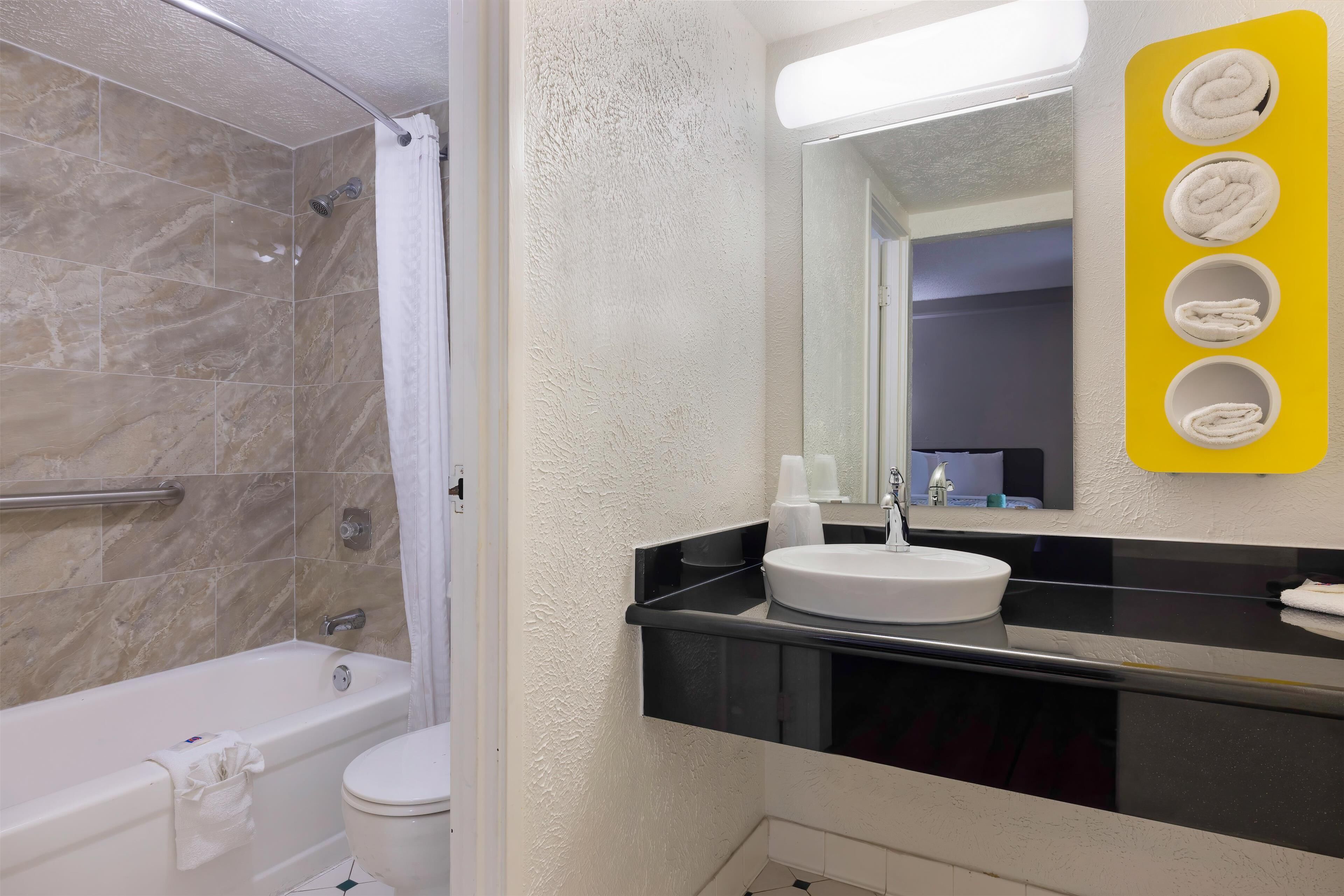 Combined shower/bathtub, towels, toilet paper