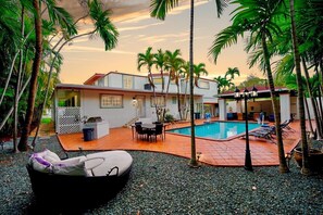 A house with a swimming pool, outdoor seating, and palm trees. - NEW Pool, Arcade Room, Open Concept Kitchen, & More at Your Own Miami Villa (Miami)