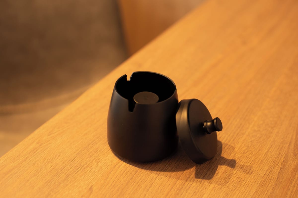 A black teapot on a wooden surface.