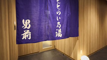 A room with wooden paneling and a purple banner with white text.