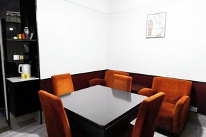A conference room with a rectangular table and six orange chairs. - Vines Fashion Hotel Lianyungang (Lianyungang)