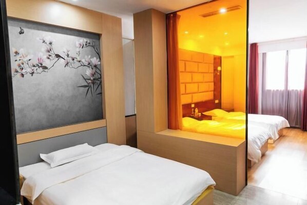 A hotel room with a bed, a painting on the wall, a window with curtains, and a view of the outside.