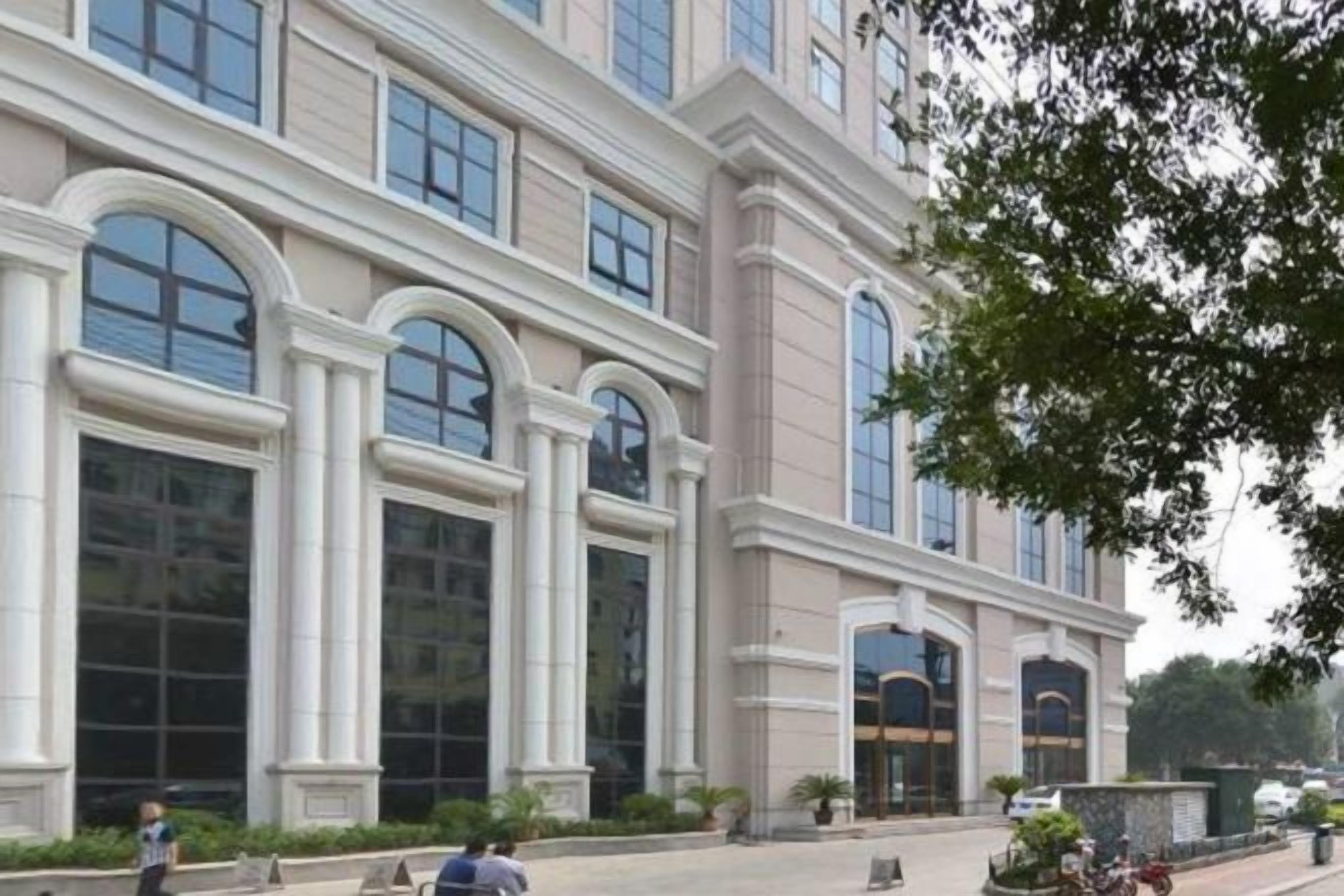 A large building with multiple arched windows and a symmetrical facade.