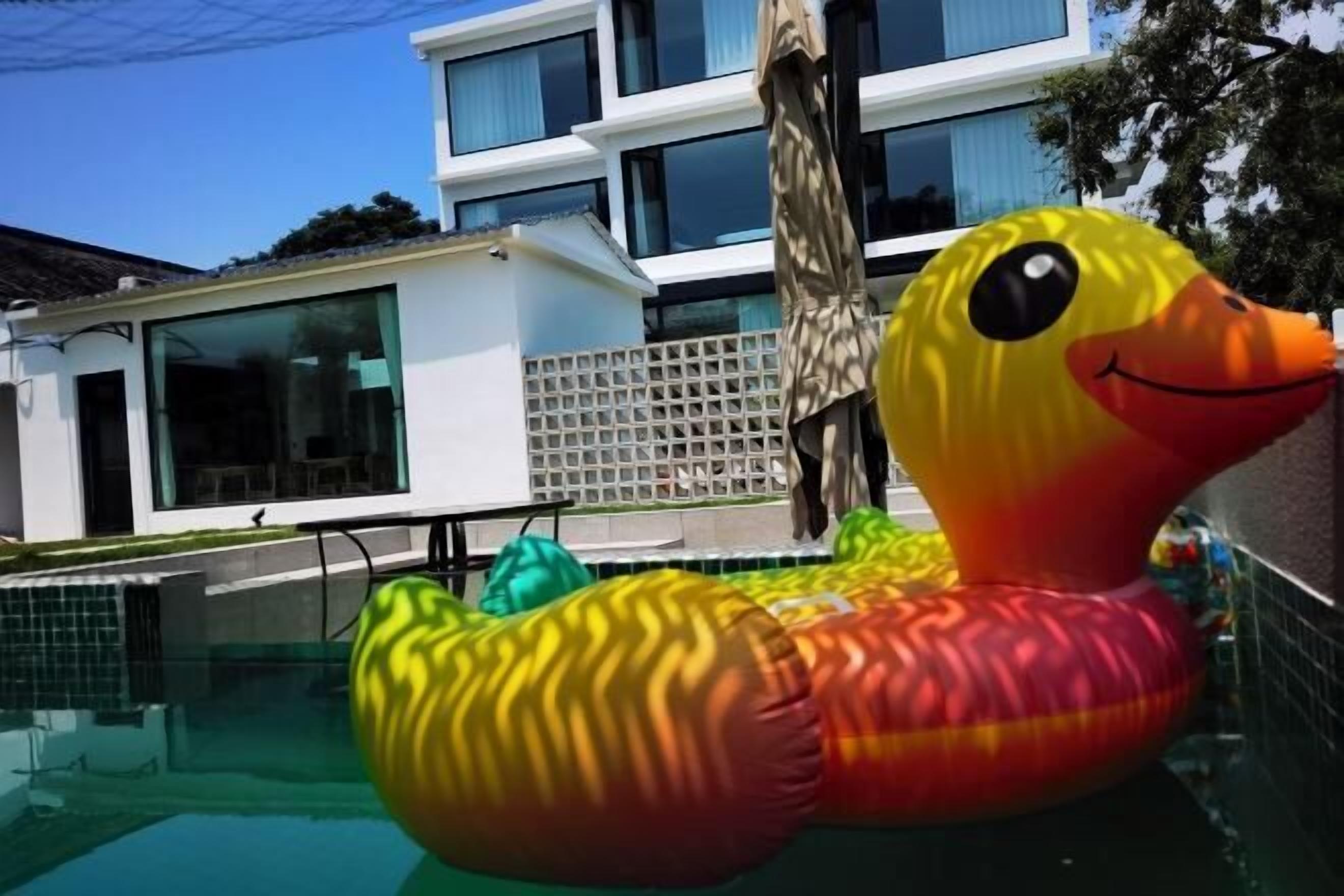 A swimming pool with a large inflatable duck decoration.