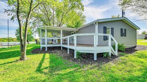 A single-story house with a covered porch and a small deck, surrounded by a grassy yard and trees. - Near Hiking & Fishing: Dale Home w/ Deck! (Dale)