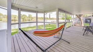 A covered deck with a hammock, wooden flooring, and a view of a lake. - Near Hiking & Fishing: Dale Home w/ Deck! (Dale)