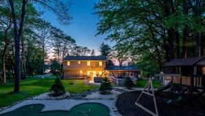 A two-story house with a swimming pool, a tennis court, and a swing set. - Dream House | HotTub+Game Room | 11mi to Camelback (Pocono Summit)