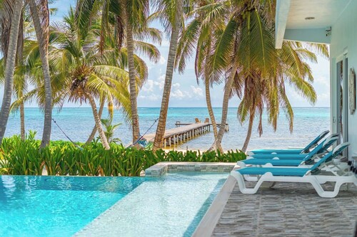 Escape to this stunning 4-bedroom villa nestled on the white sands of northern Ambergris Caye, Belize.