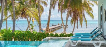 Escape to this stunning 4-bedroom villa nestled on the white sands of northern Ambergris Caye, Belize.