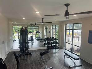 A gym with exercise equipment, a treadmill, and a rack of dumbbells. - Ideal for long stays, great location, King bed! (Spartanburg)