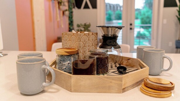 A tray with a coffee maker, jars, and mugs on a table. - Ideal for long stays, great location, King bed! (Spartanburg)