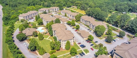 A residential complex with multiple apartment buildings, parking areas, and green spaces.
