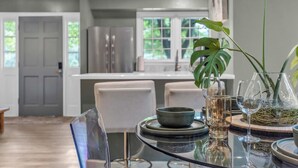 A modern kitchen with a dining area.