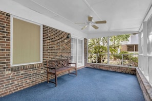 A covered outdoor seating area with a bench, a ceiling fan, and a view of the outdoors. - 2 King Beds - Perfect for long stays @Laguna House (Spartanburg)