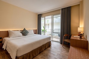 Relax in comfort with a large bed, desk, and outdoor area with a view.