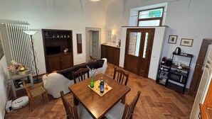 A spacious kitchen with a dining table, chairs, and a built-in oven.