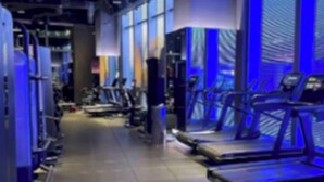 A gym with treadmills, weight machines, and exercise equipment.