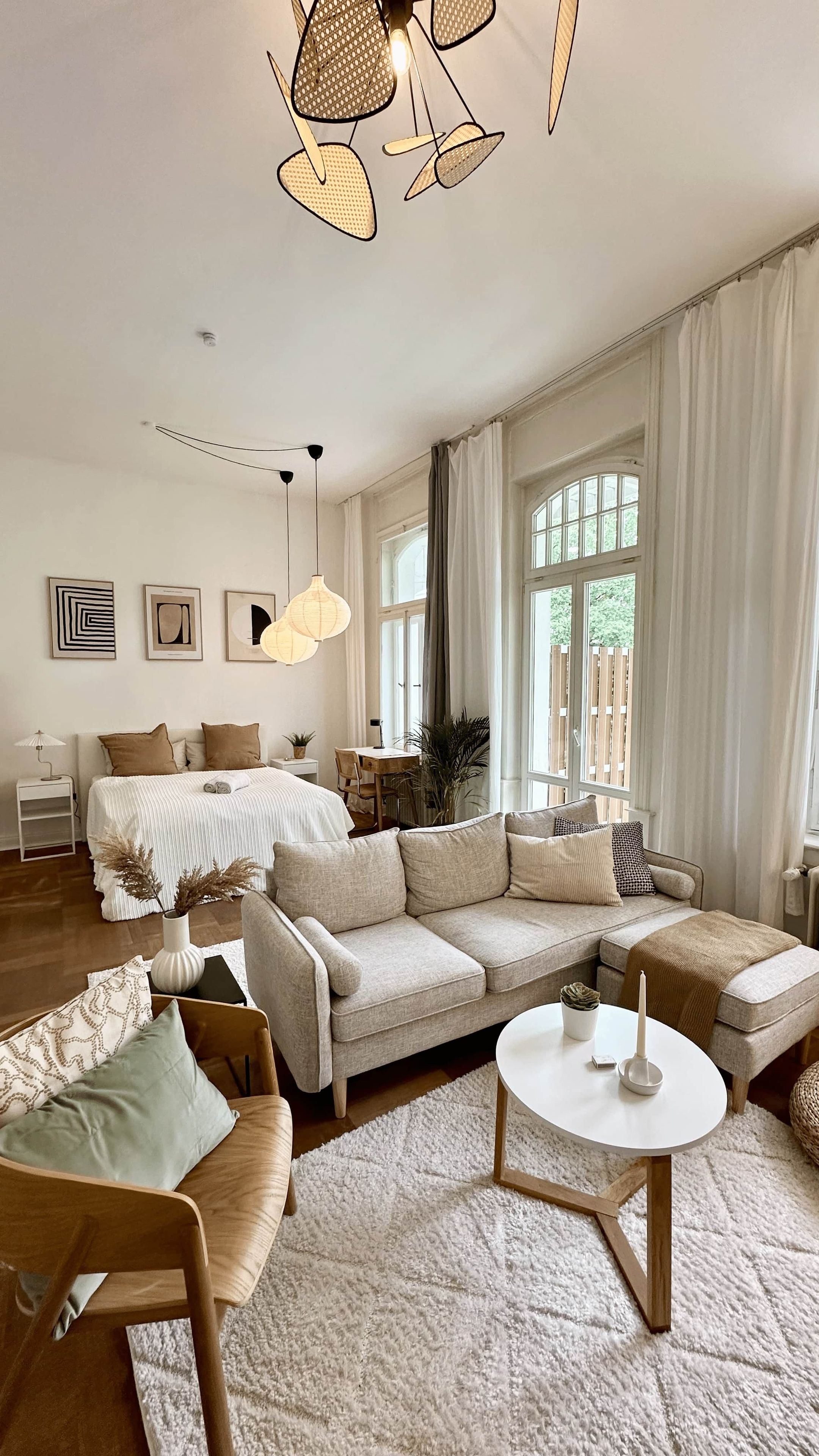 A spacious living room with a large sofa, a coffee table, and a dining area.