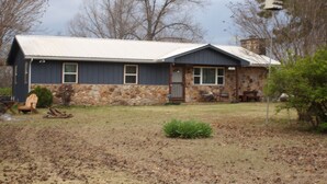A two-story house with a stone facade and a metal roof. - Charming 3-bedroom house with WiFi, AC in delightful Yellville (Yellville)