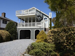 A two-story house with a balcony, a garage, and a number 119 on the front.