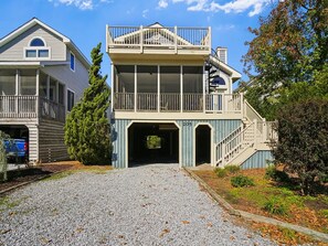 A two-story house with a covered entryway and a balcony.