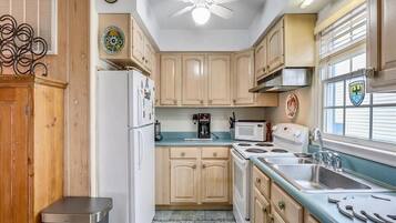 Enjoy cooking in this well-equipped kitchen with a gas stove, microwave, and sink.