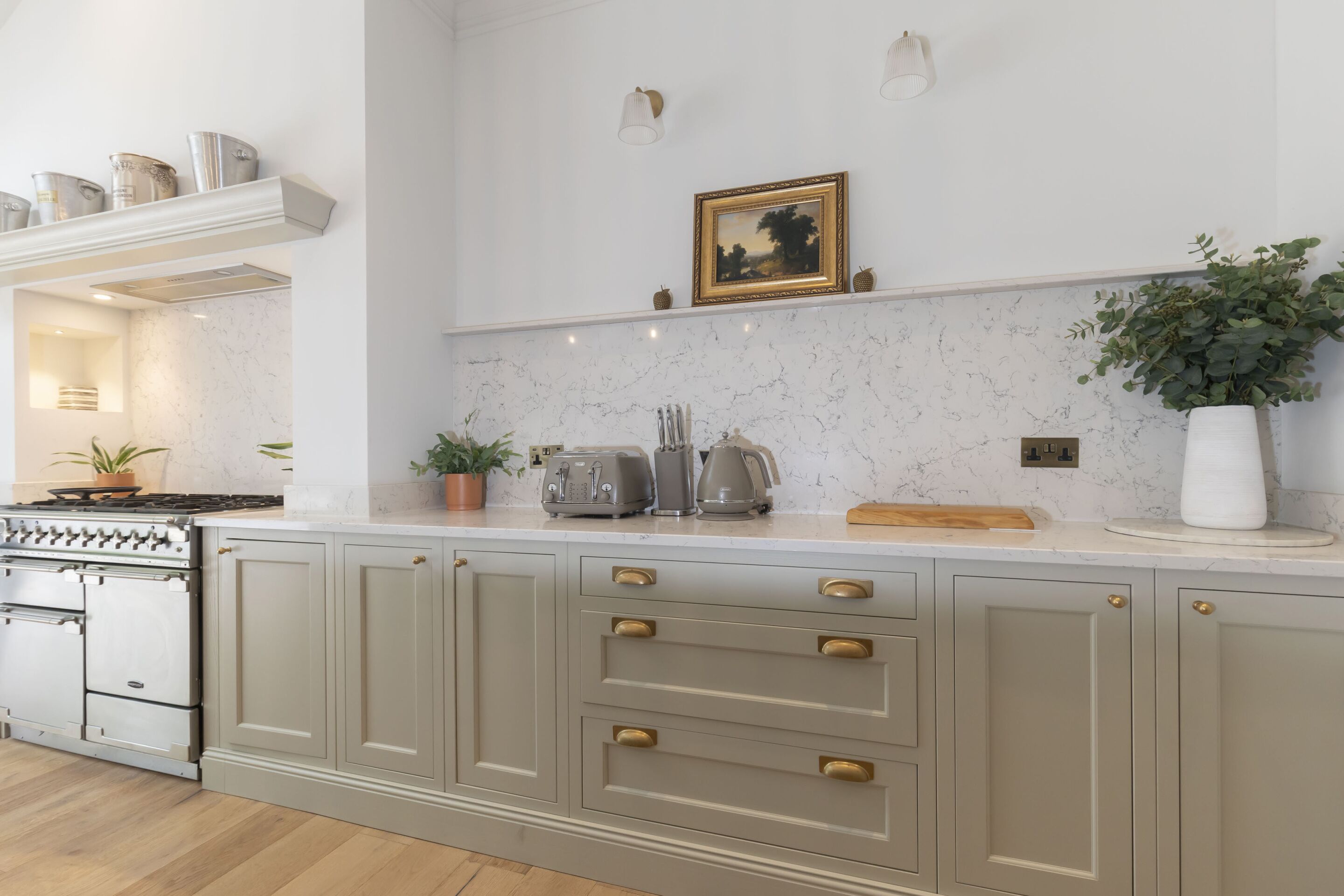 A kitchen with a built-in stove, cabinets, and a countertop with various appliances.