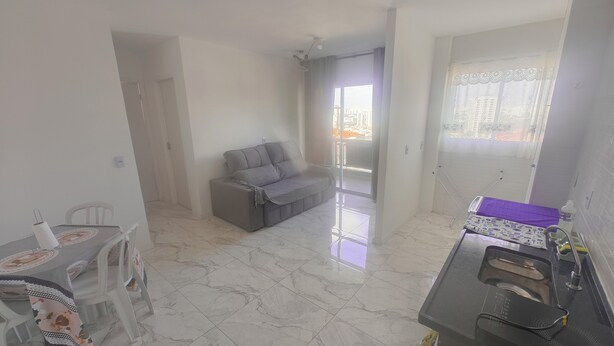 A modern apartment with a dining area, a sofa, a balcony, and a kitchenette. - Fairs and Shopping 202 (Vila Maria Alta São Paulo)