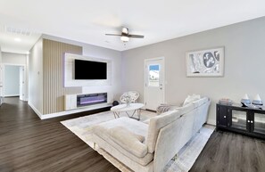 TV connectée, cheminée, livres, chaîne hi-fi